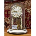 A Kundo German anniversary clock with glass dome,