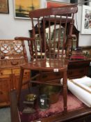 A brown painted Windsor carver armchair (1 leg replaced)