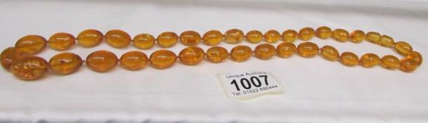 A honey coloured amber bead necklace.