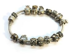 A silver Pandora charm bracelet with charms