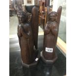 A pair of carved wood kneeling angels.