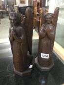 A pair of carved wood kneeling angels.