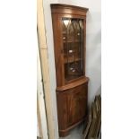 A medium stained corner cupboard with astragal glazed top