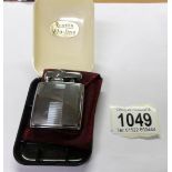 A vintage Ronson lighter in original plastic case.