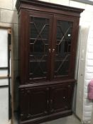 A dark wood stained glaze bookcase with cupboard base