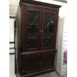 A dark wood stained glaze bookcase with cupboard base