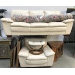 A cream leather 3 seater sofa,