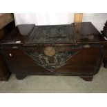 A carved chest with ship motif.