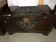 A carved chest with ship motif.