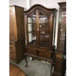 A mahogany display cabinet on 2 drawer base.