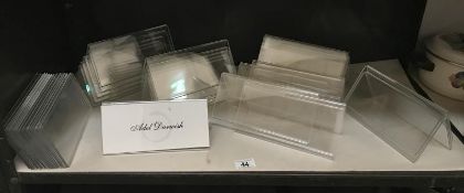 A quantity of clear plastic name stands for place settings/seminars etc.