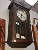 A wall clock with key and pendulum