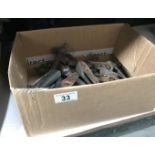 A box of vintage stair carpet rods