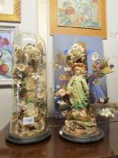 A pair of continental bisque figurines, one under glass dome and the other with dome missing.