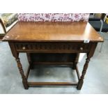 A medium oak hall table with drawer