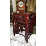 A nest of 3 oriental carved wood tables