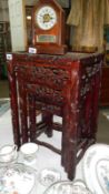 A nest of 3 oriental carved wood tables