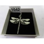 A dragon fly pendant on chain,.