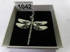 A dragon fly pendant on chain,.