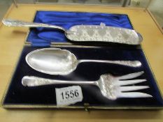 A cased pair of silver plate salad servers and a crumb scoop.
