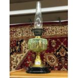 A Victorian oil lamp with vaseline glass font