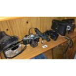 A quantity of camera's & binoculars including Canon & Zeiss etc.