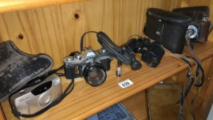 A quantity of camera's & binoculars including Canon & Zeiss etc.