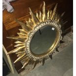 An ornate "sun" mirror.