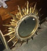 An ornate "sun" mirror.
