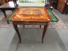 A marquetry inlaid games table with chess board, roulette etc.