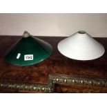 A green glass lamp shade and a white glass lamp shade.