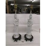 A pair of ceramic table lamps in the form of Chinese figures, need re-wiring.