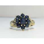 A 9ct gold ring set with 9 sapphires & pave diamonds to shoulders