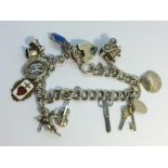 A silver charm bracelet with charms including silver