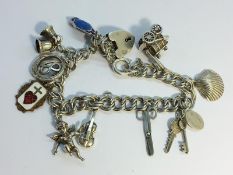 A silver charm bracelet with charms including silver