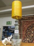 A Cornish serpentine lighthouse table lamp with 1960's orange fibre glass shade.