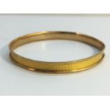 A 9ct gold bangle (13 grams)