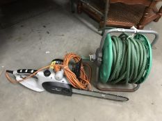 A Spear & Jackson chainsaw and a hosepipe