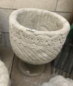 A Mayan circular planter decorated with aztec design