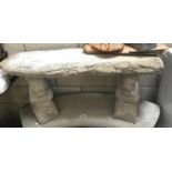 A straight stone seat on squirrel plinths
