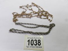 A long unmarked yellow metal chain and a white metal chain.