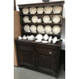 A dark oak dresser with carved front