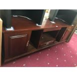A dark wood stained low wall unit with cupboards & drawer