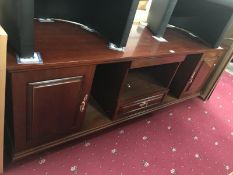 A dark wood stained low wall unit with cupboards & drawer