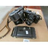 A Voigtlander Bessa folding camera and a Zenith E camera.