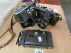 A Voigtlander Bessa folding camera and a Zenith E camera.