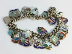 A silver charm bracelet with silver & enamel charms