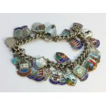 A silver charm bracelet with silver & enamel charms