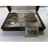 A cased set of 6 Walker and Hall silver teaspoons with golfing motif.