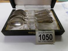A cased set of 6 Walker and Hall silver teaspoons with golfing motif.